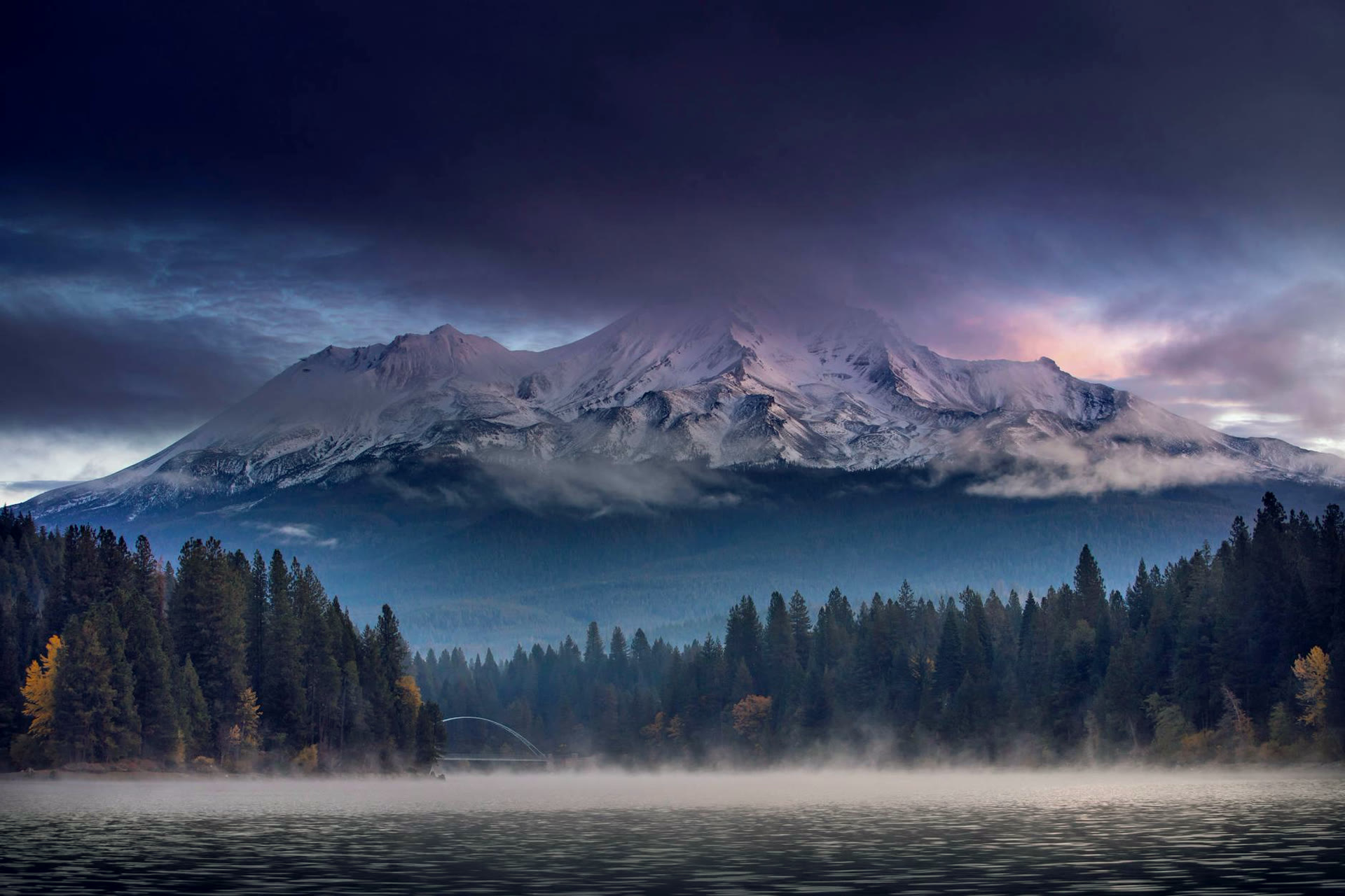 Mount Shasta at twilight above mist and water
